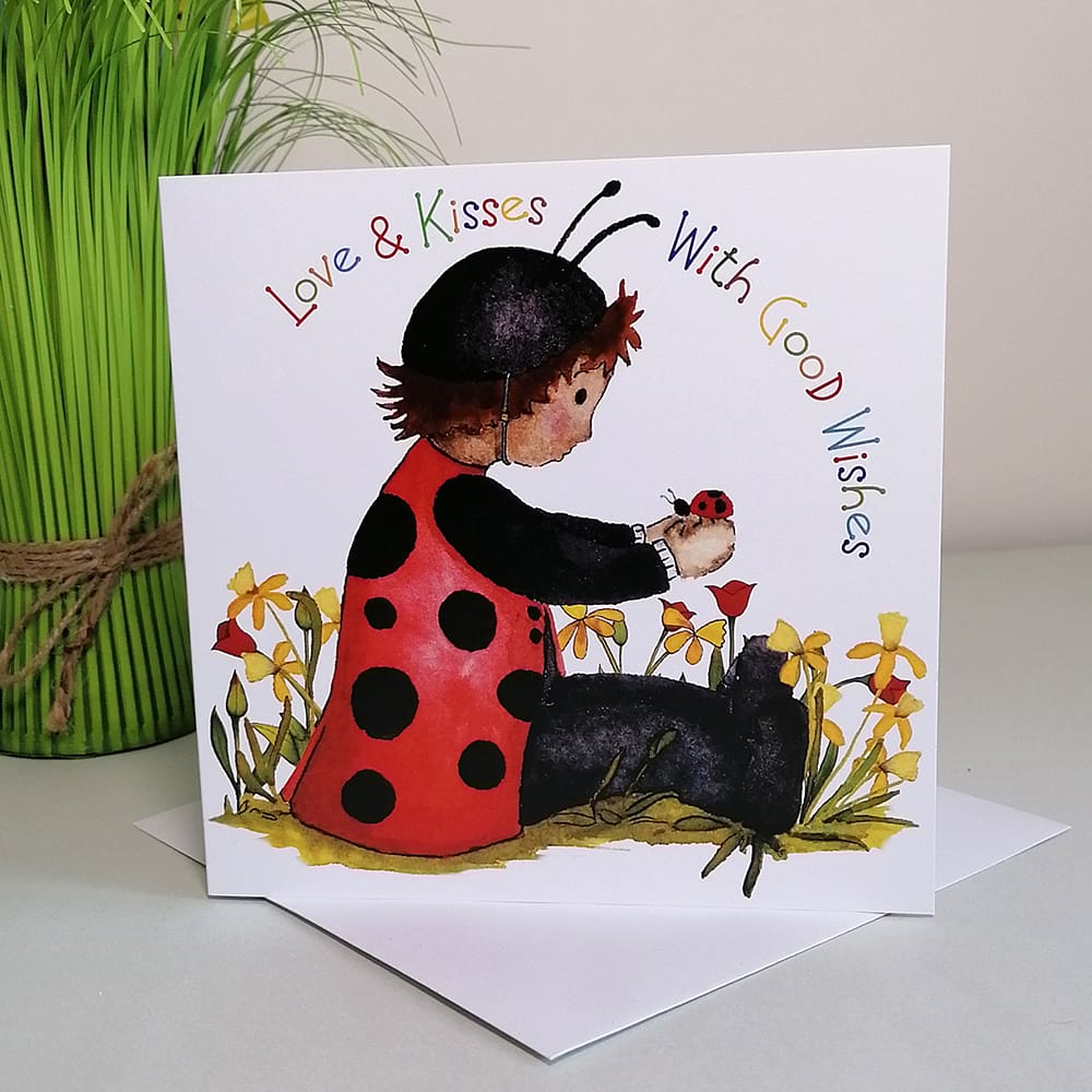Square colourful greetings card for kids featuring Dorothy in her poppy red and black ladybug costume chatting to a ladybird in the garden.