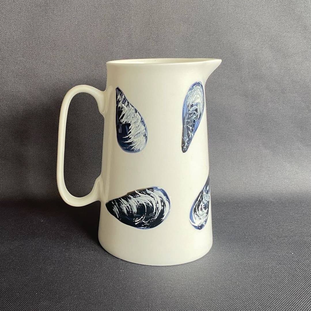 Small white ceramic jug hand painted with mussels