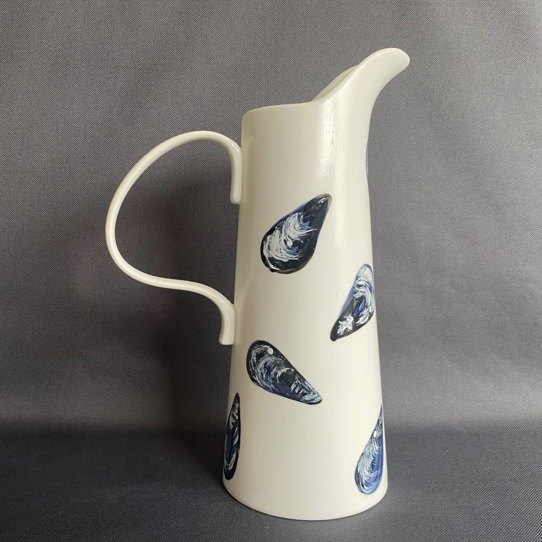 Tall white ceramic jug hand painted with mussels