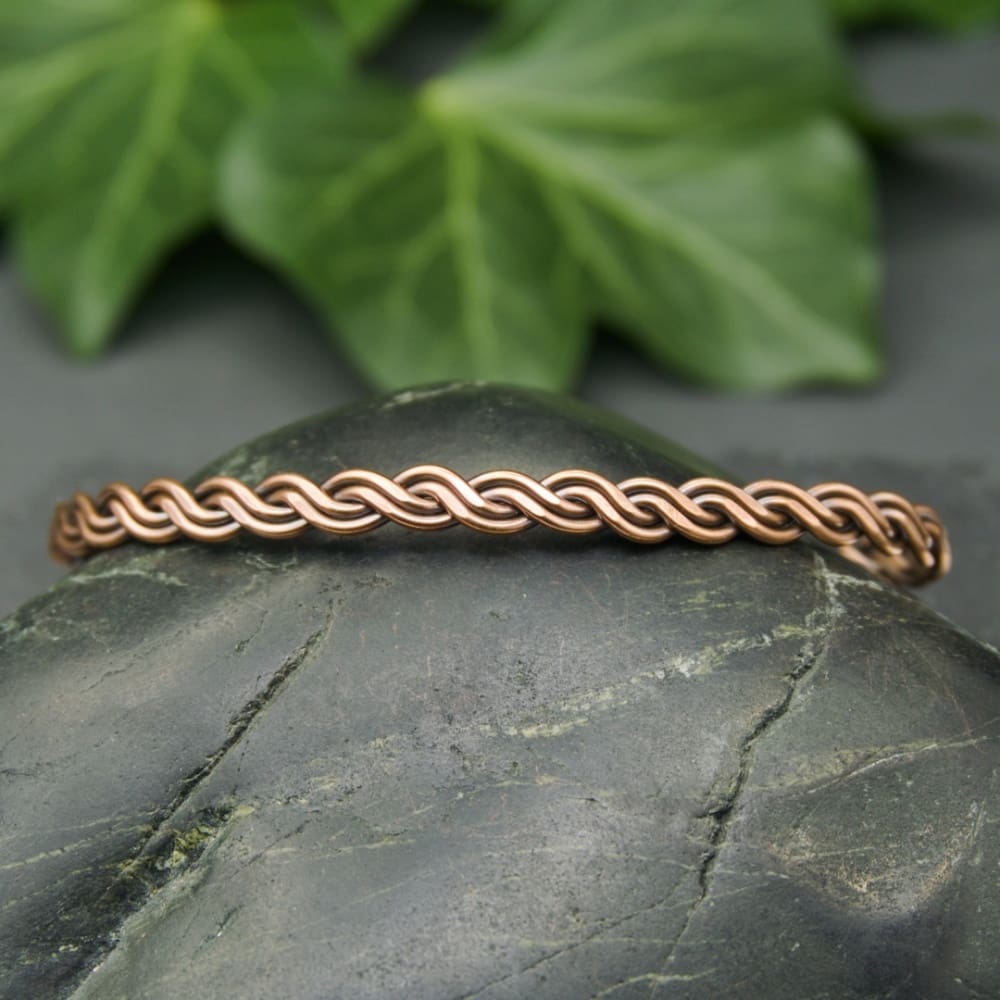 Handcrafted narrow twisted copper bangle