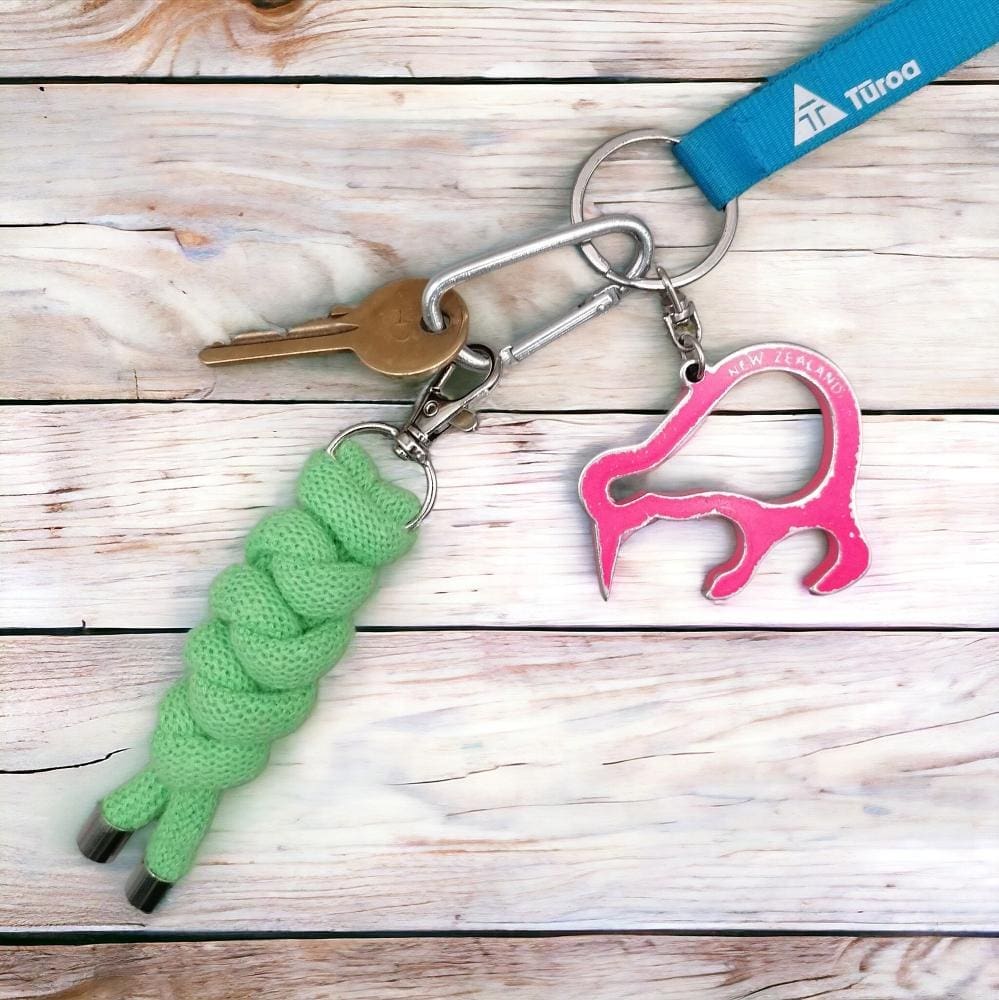 Chunky neon green knotted cord keyring shown on a bunch of keys which is displayed on a light wooden background.