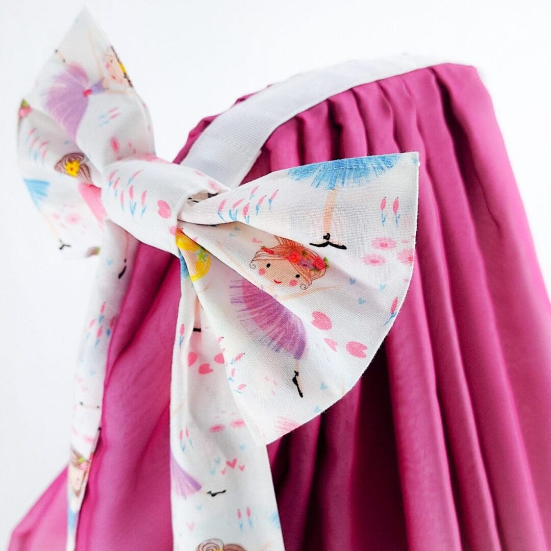 Large pink bow attached to the cot canopy.