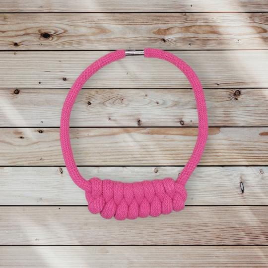 Flatlay view of pink chunky knot detail rope necklace