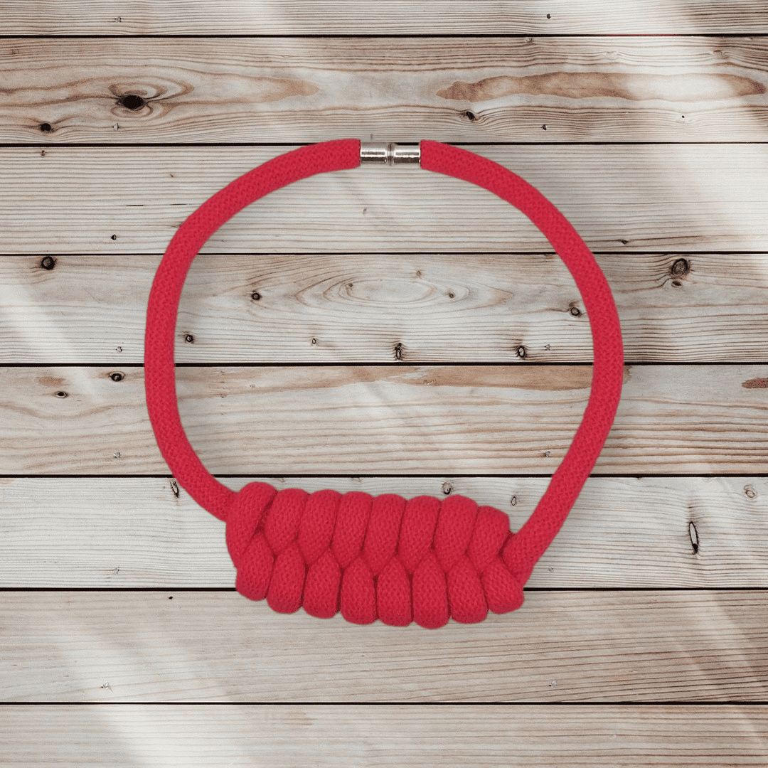 Flatlay view of chunky red statement knot necklace