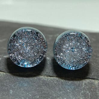 A pair of silver fused dichroic glass studs viewed from the front