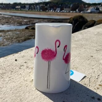 Small White Ceramic Jug with Pink Flamingos and view of North Berwick behind.