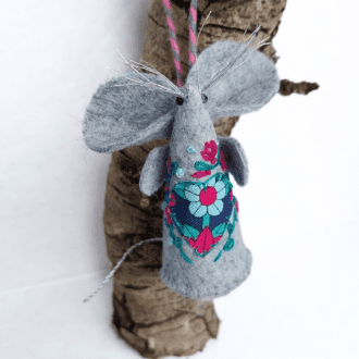 a handmade felt and fabric mouse with a liberty applique heart and hand embroidery