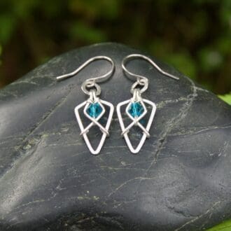 Handmade sterling silver earrings with arrowhead shape and turquoise glass beads