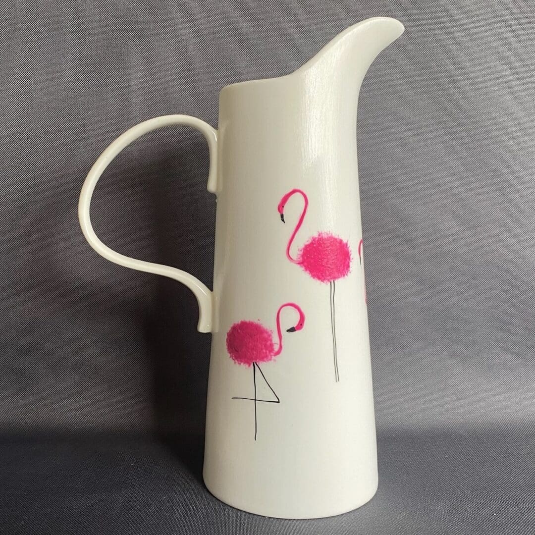 White Jug decorated with Pink Flamingo against a grey background