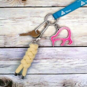 Chunky Yellow keyring made from knotted recycled cotton cord, displayed on a light wooden background