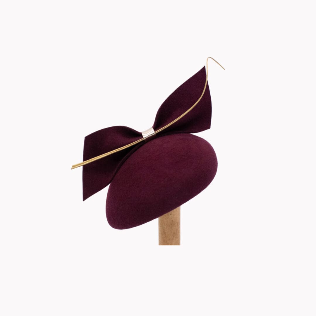 maroon felt cocktail hat with gold feather