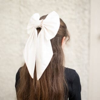 bridal silk hair bow modelled on half-up half-down hairstyle