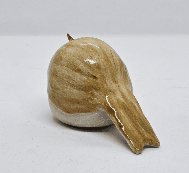 Rear side view of ceramic chiffchaff on a white background