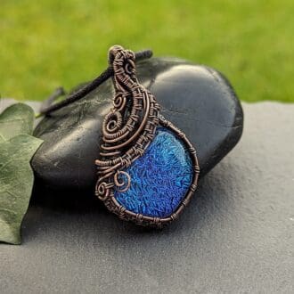 Asymmetric wire wrapped pendant with chunky blue dichroic glass cabochon