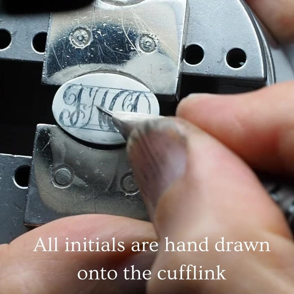 drawing entwined initials onto silver cufflinks