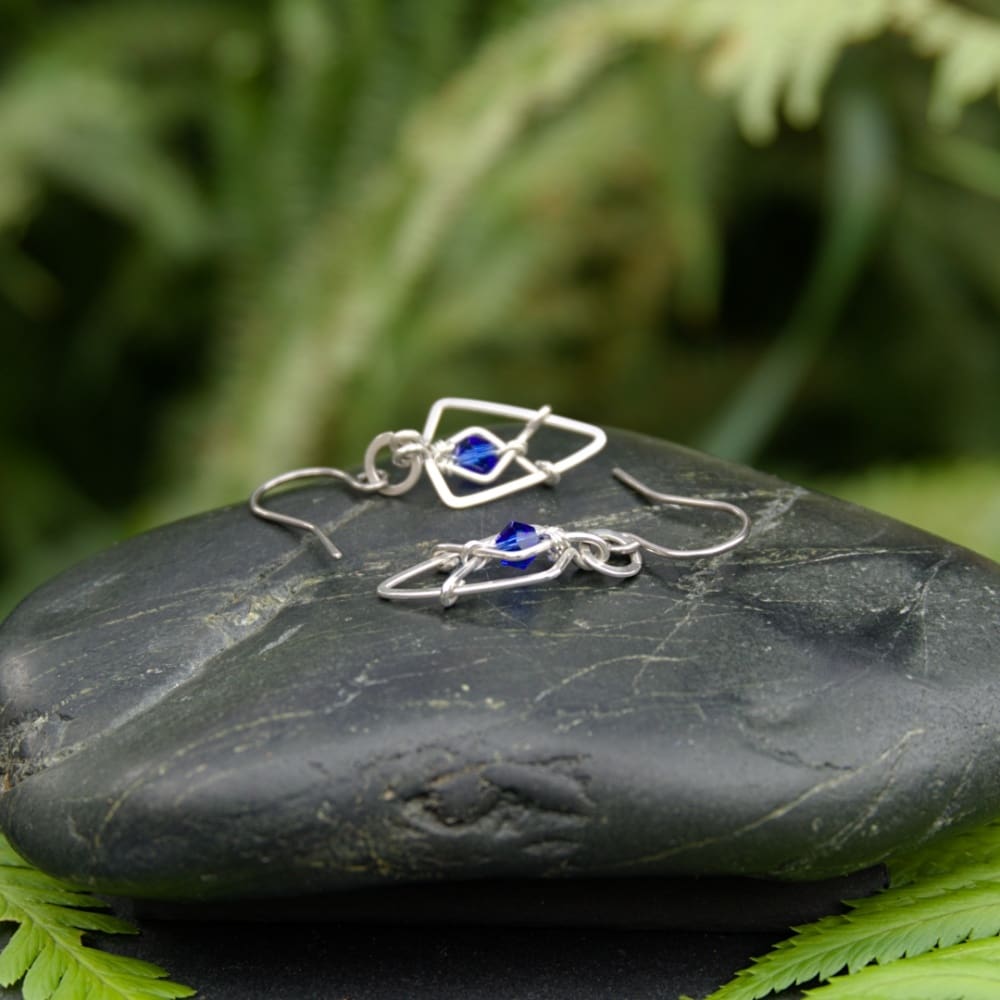 Silver geometric arrowhead earrings with blue beads