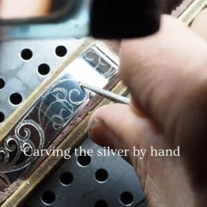 engraving scroll design on silver cuff bracelet by hand