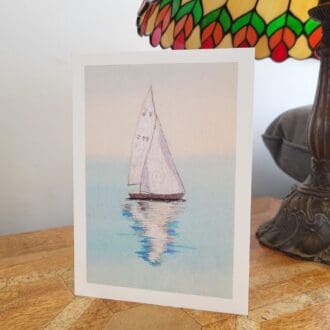 print of original embroidery of a sailing boat on tranquil waters. 5 x 7 inch greetings card.