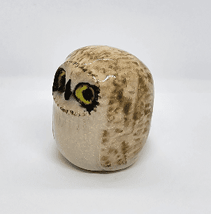 Ceramic short eared owl, yellow eyes on white background