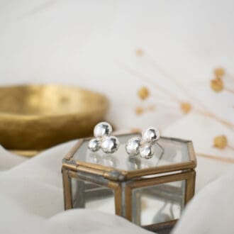 trio of silver pebbles clustered to form a stud earring