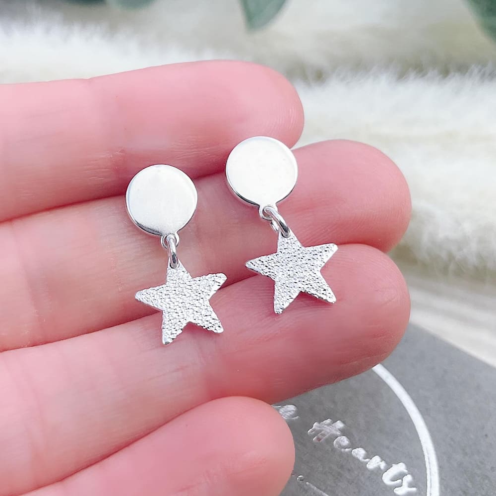 star earrings in hand