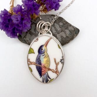 Beautiful pendant in a bird on branch design made from a broken Anisley pottery plate set in sterling silver on a silver chain