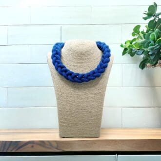 Blue chunky knotted rope necklace displayed on a light coloured bust model against a light background