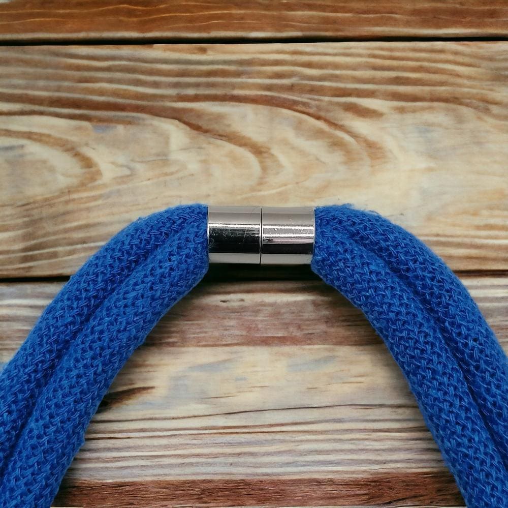 Magnetic clasp detail close up on chunky blue statement necklace.