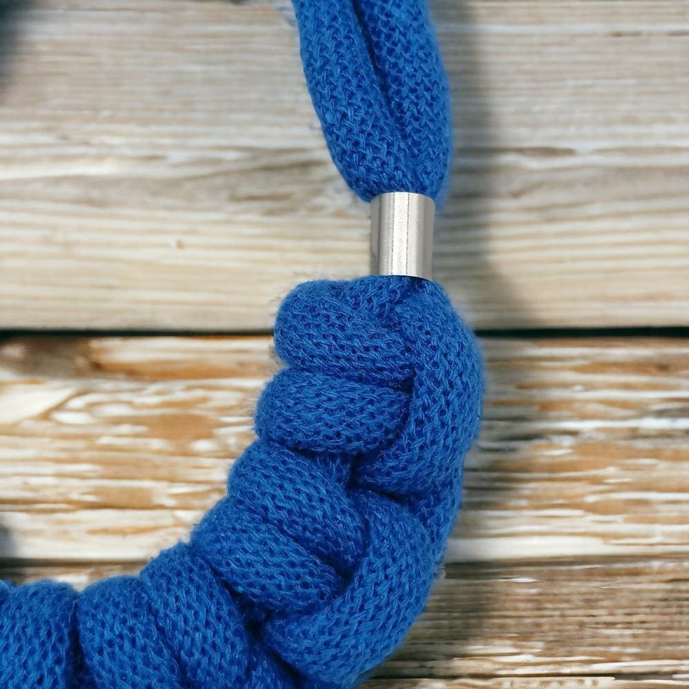 Close up of knot feature on chunky blue statement rope necklace.