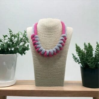 Pink and Grey statement chunky knotted necklace shown on a model bust against a light background