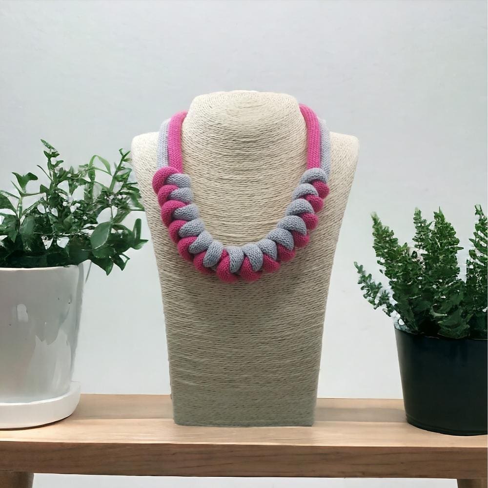 Pink and Grey statement chunky knotted necklace shown on a model bust against a light background