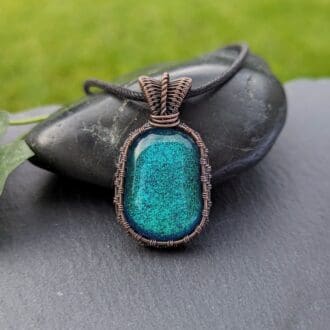 Handmade copper wire wrapped pendant with green dichroic glass nugget