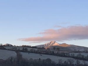 Brecon Beacons pink sky snow on mountains