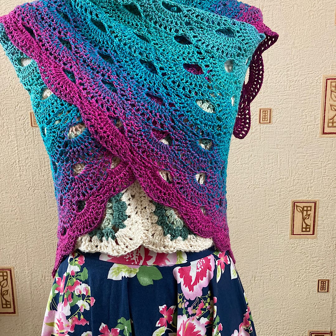 A handmade crochet cotton shawl in ombré hues