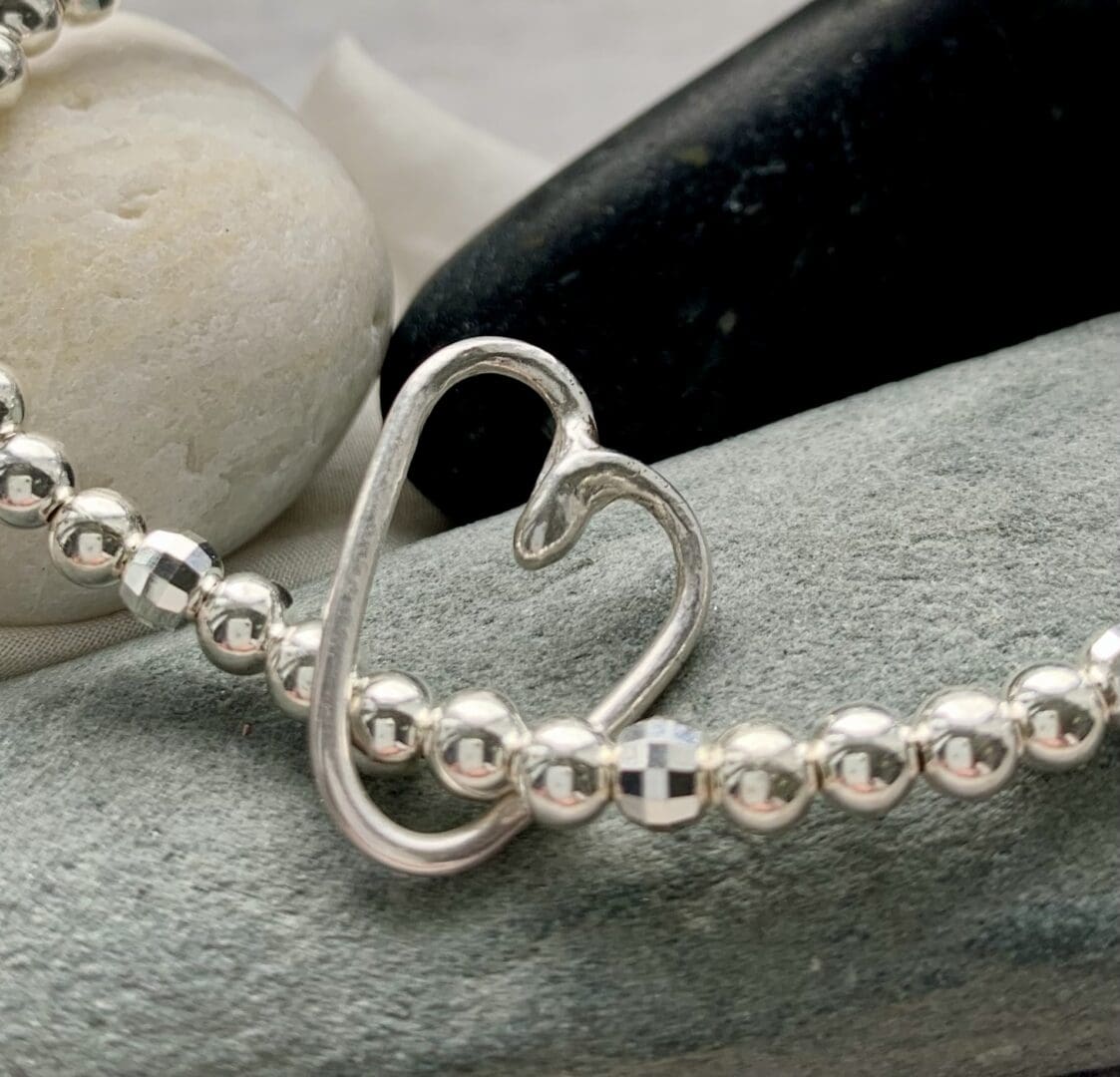 sterling silver stretch bracelet with recycled fused heart charm