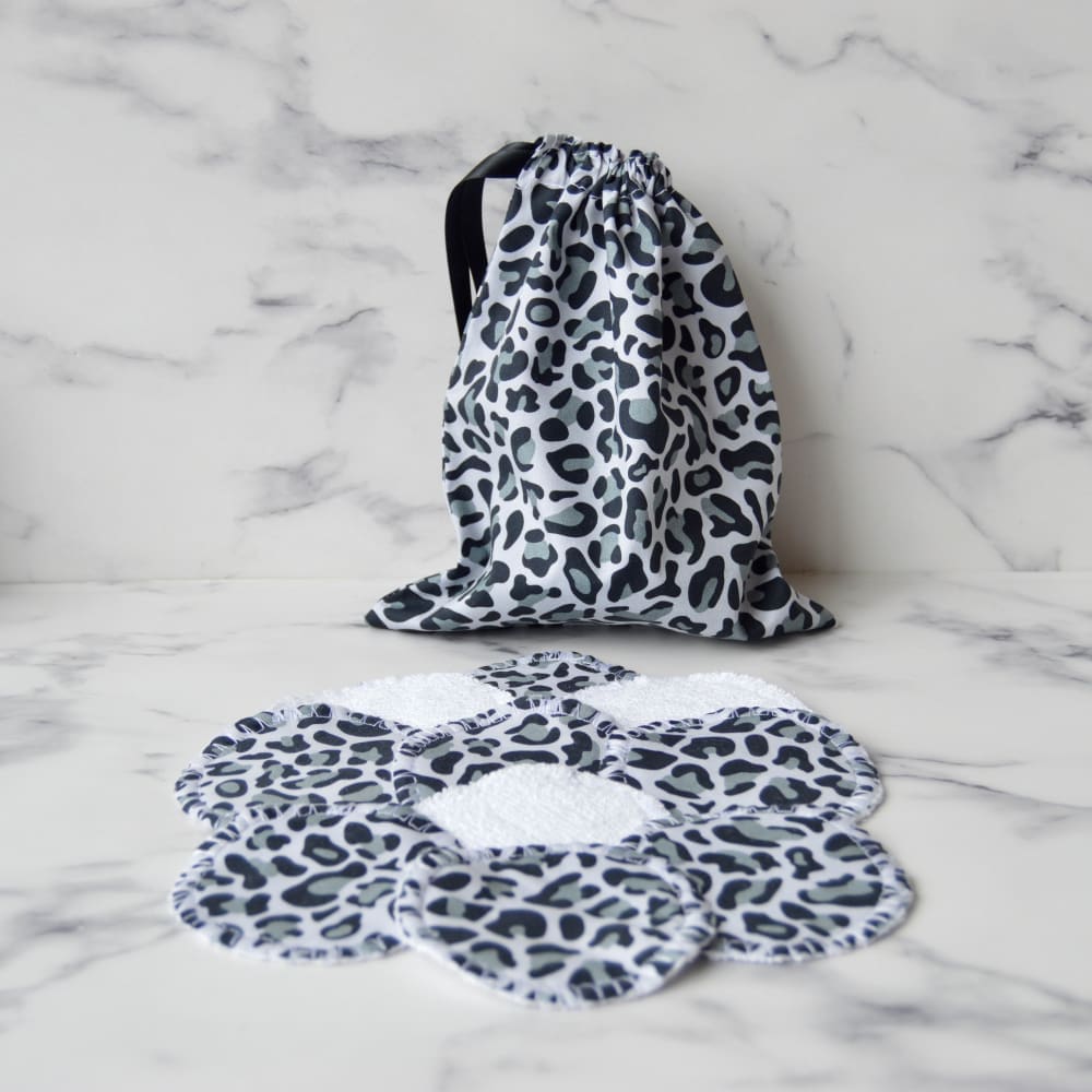 Reusable cotton pads with matching storage bag. Fabric is leopard print in grey and black. The bag has a black ribbon drawstring