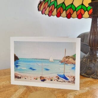 Print of embroidery as a greetings card. Little haven beach in Pembrokeshire, sailing boat on shoreline. 5 x 7 inches