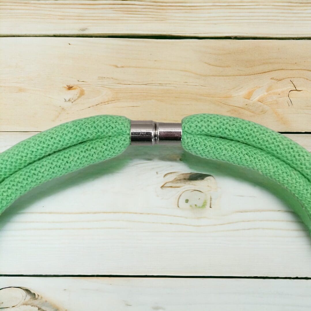 Close up of magnetic clasp on chunky statement neon green rope necklace