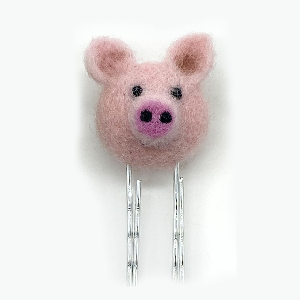 Handmade needle felted pig bookmark, made from 100% wool and attached to a paperclip