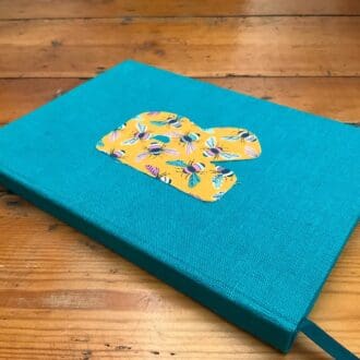 Fabric covered notebook filled with plain paper and personalised with a letter R