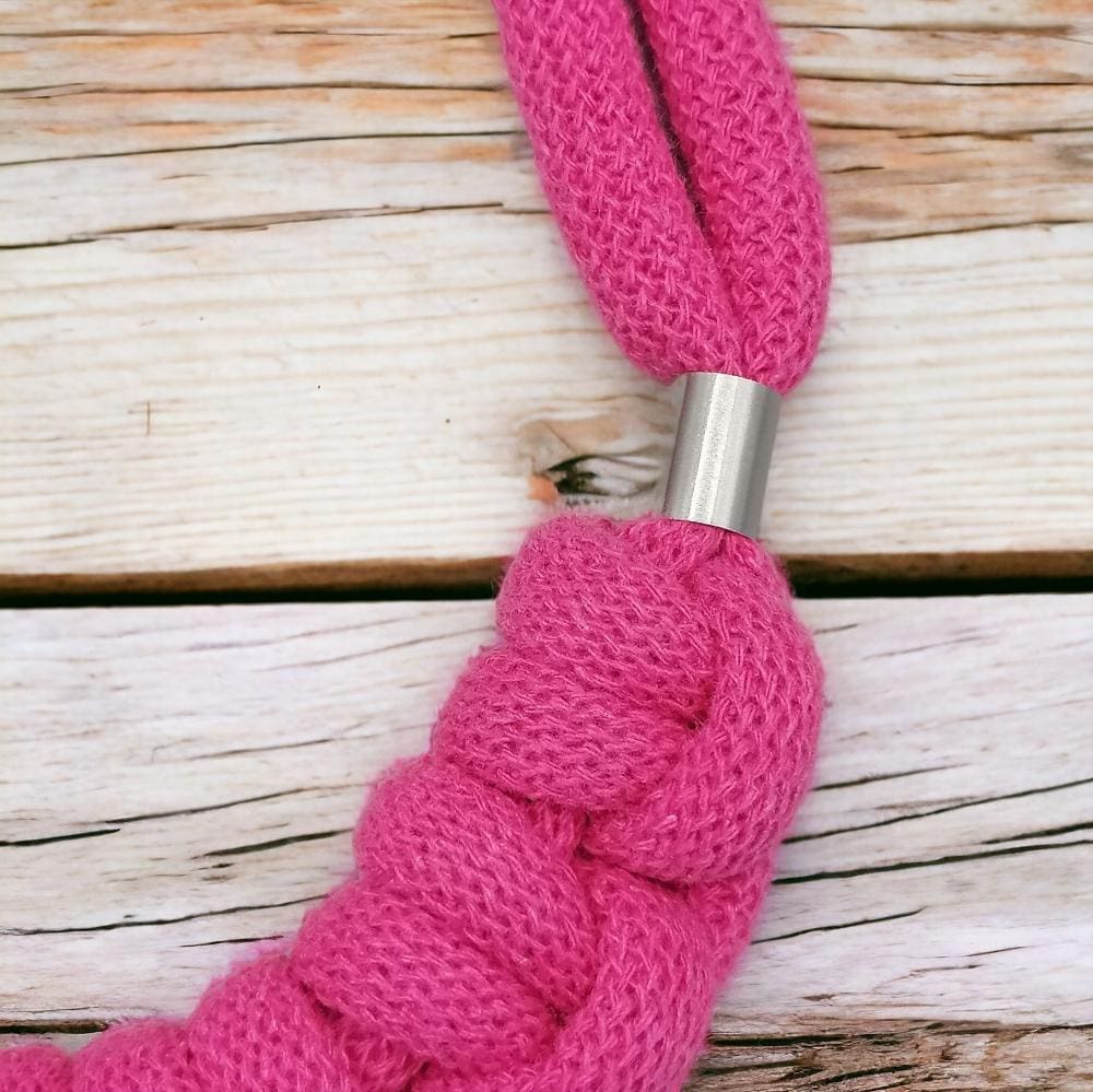 Close up of pink knotted chunky statement macrame necklace.