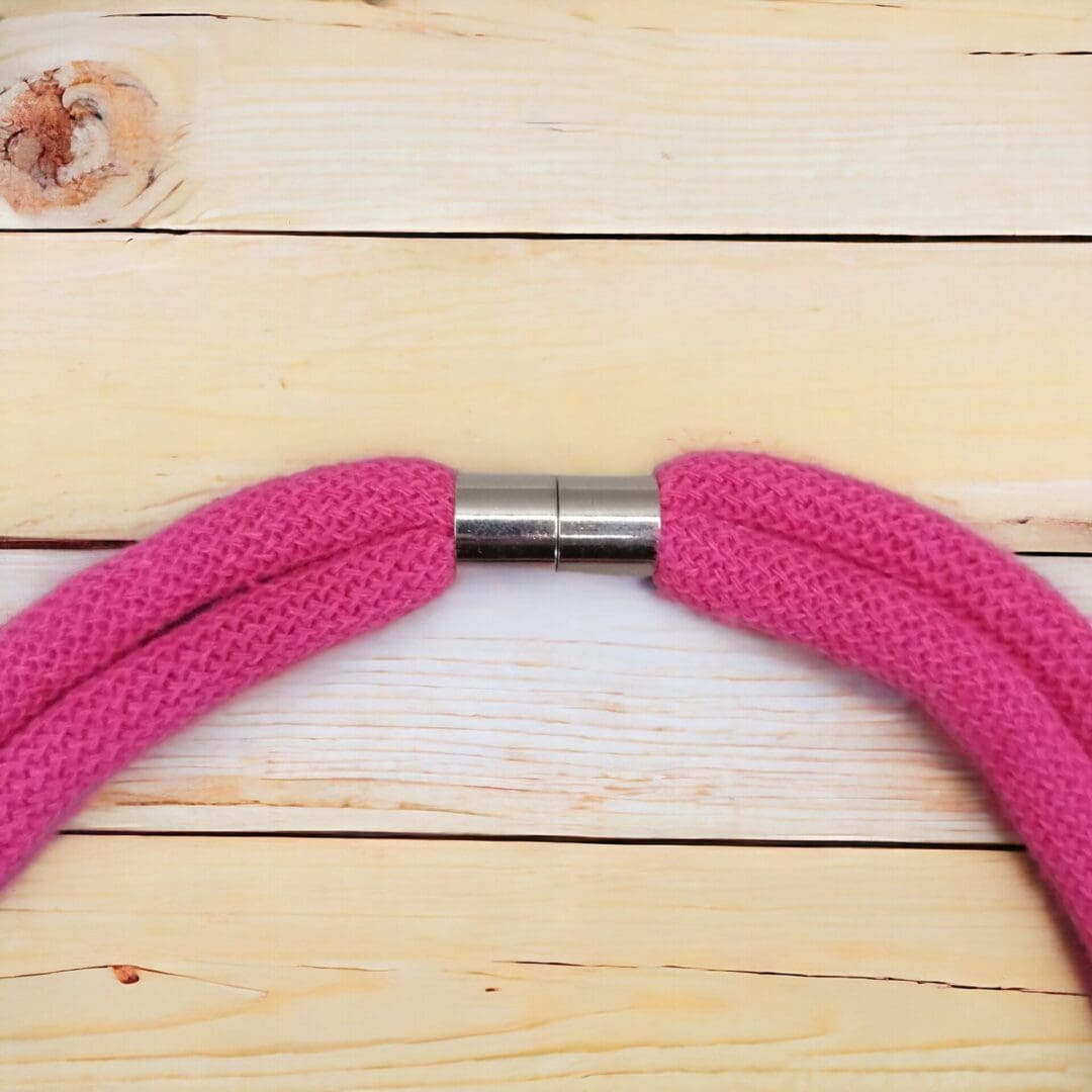 Close up of magnetic clasp on statement pink chunky rope necklace