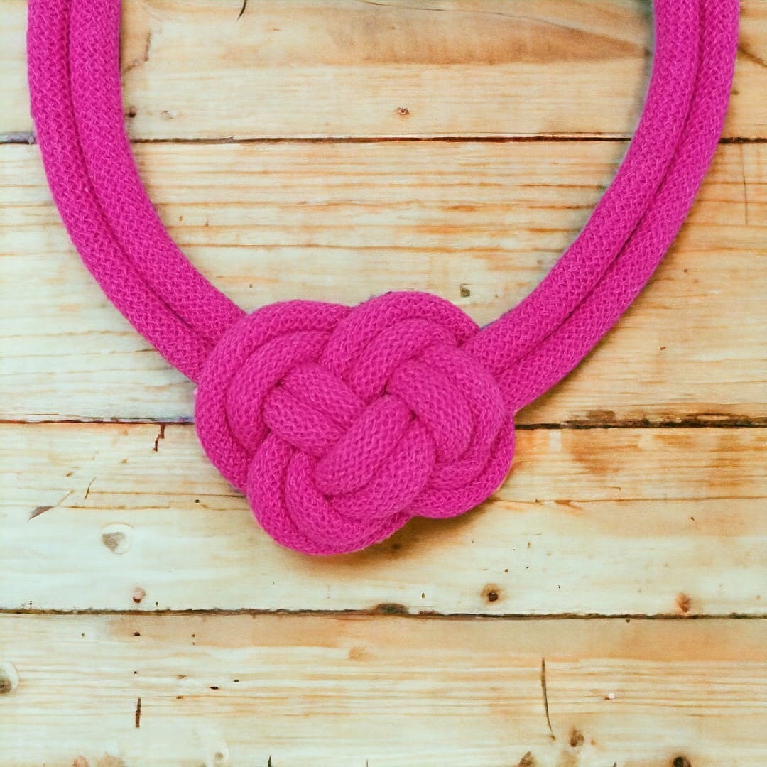 Close up of knot detail on chunky pink knotted statement necklace
