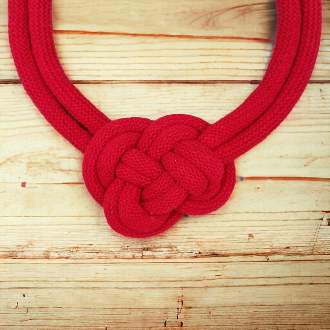 Close up of knot feature on chunky red rope necklace