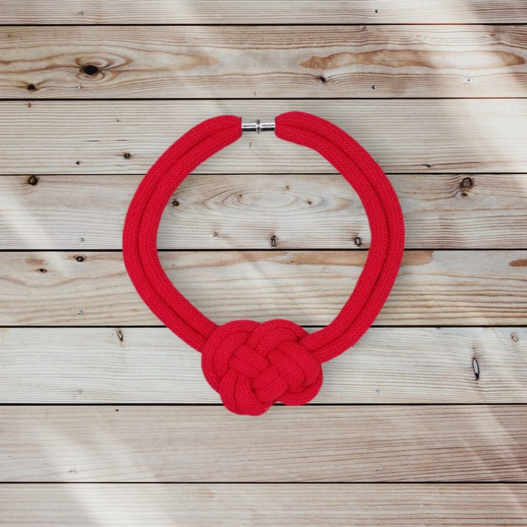 Flatlay overhead view of knotted red rope necklace