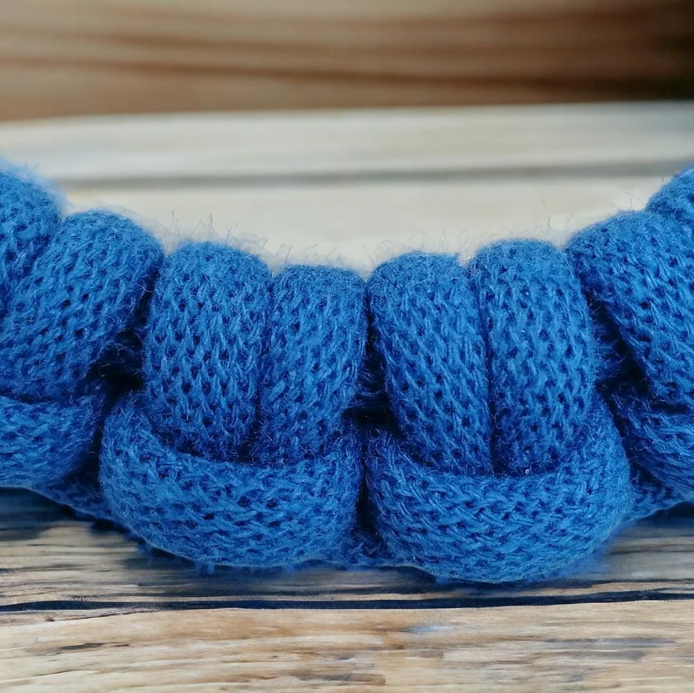 Knot detail close up on statement blue chunky knotted rope necklace.