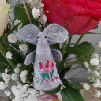 A handmade and embroidered felt mouse with a summer flowers theme
