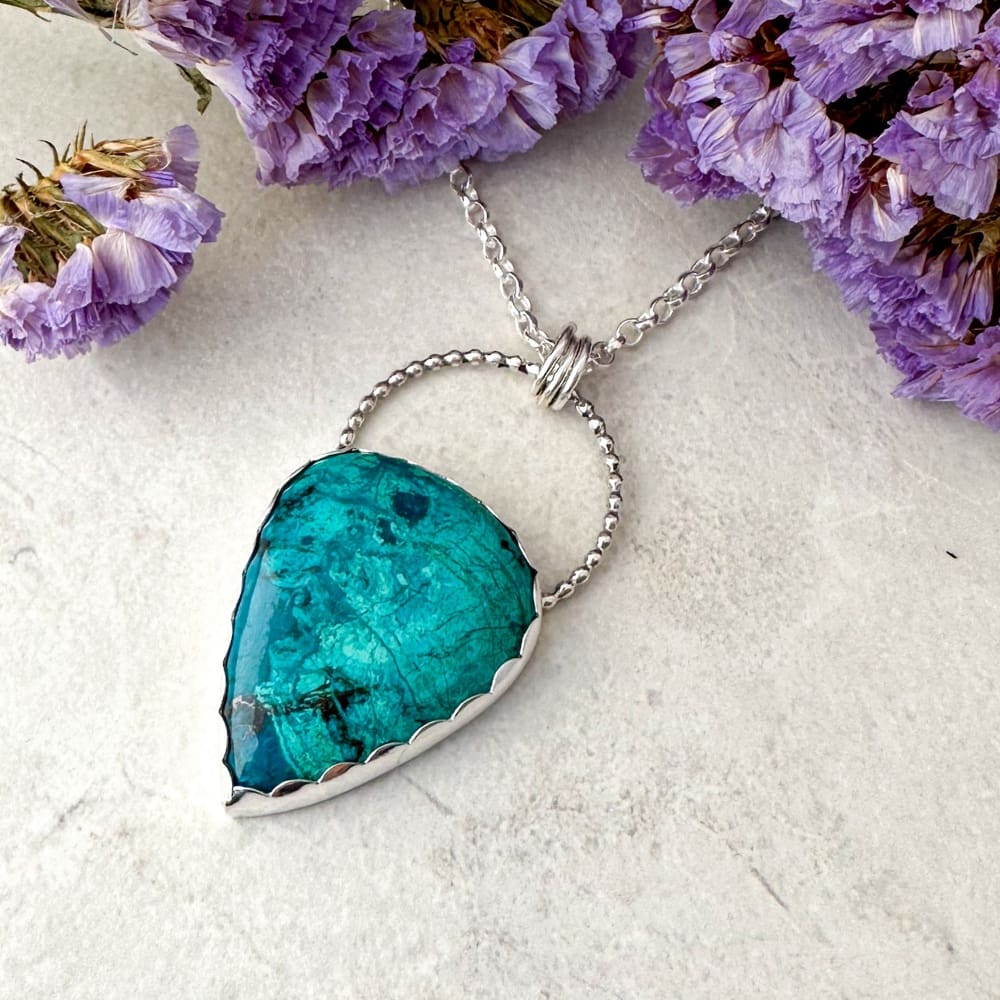 Turquoise green shattuckite gemstone set in a handmade silver necklace