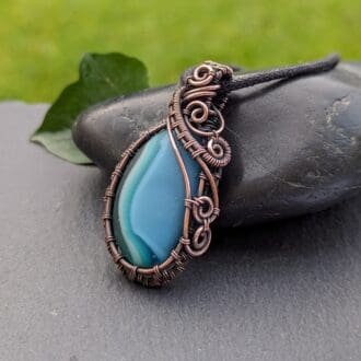 Handmade copper wire wrapped pendant with pale blue fused glass pebble