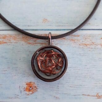 copper and resin pendant on rubber necklet
